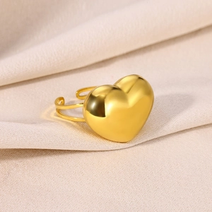 Macro shot of a polished gold heart ring featuring a double-layered adjustable band