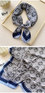 Detail of navy blue and off-white satin silk scarf featuring retro geometric patterns