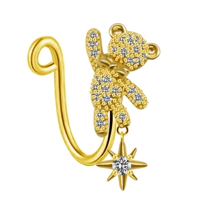 Detail of gold bear nose clip featuring zircon pave and a dangling star pendant