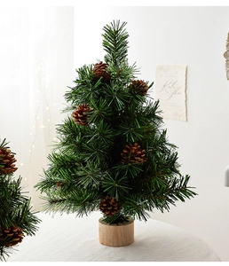 Close-up of small pine cone Christmas trees with green needles on round wooden bases
