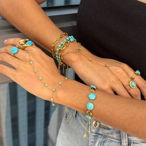 Bohemian gold stainless steel jewelry set with turquoise stones worn by a model