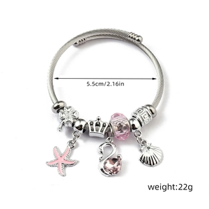 Detailed view of stainless steel charm bracelet with pink starfish and swan pendants