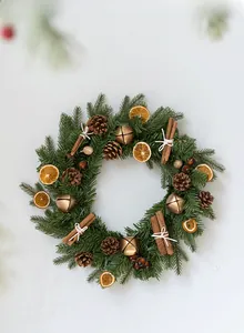 Detail of Christmas wreath with pine cones, dried orange slices and cinnamon sticks