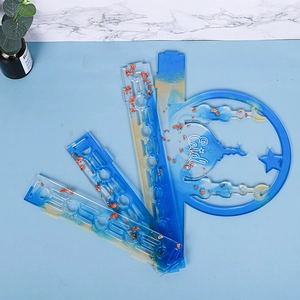 Detailed flat lay of blue and gold resin DIY Eid craft pieces with mosque silhouettes