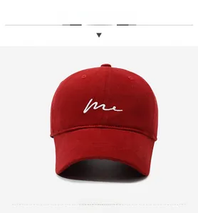 Detailed close-up of dark red baseball cap featuring white 'me' script embroidery