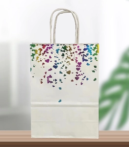 Detail of white paper gift bag with holographic rainbow heart foil and white twisted handles