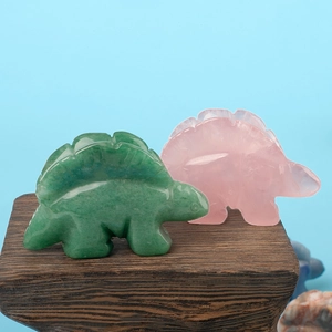 Hand-carved natural crystal dinosaur figurines in rose quartz and green aventurine