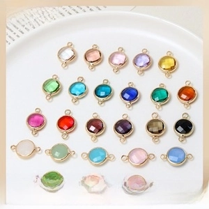 Macro detail of multi-color faceted glass pendants with gold plated double holes