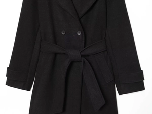 Detail of double-breasted black wool coat featuring waist belt and textured fabric