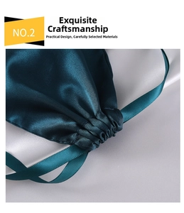 Detailed close-up of dark green satin drawstring pouch with silk ribbon and pleated stitching