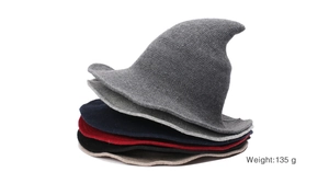 Detail of knitted witch hats in various colors showing thick yarn texture and pointed design