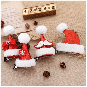 Detailed view of sequined Christmas hat hair clips with bows and snowflakes on linen background