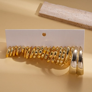 Detail of 20-piece gold-toned steel hoop earrings set on professional display card