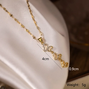 Detailed view of gold butterfly pendant with sparkling zircons and size measurements