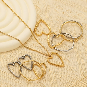Minimalist stainless steel heart and circle pendants on a gold and silver necklace
