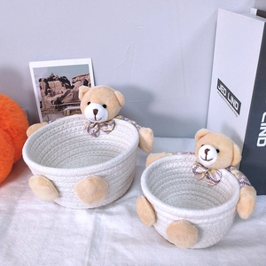 Macro shot of white woven cotton rope baskets with cute plush bear charms in two sizes