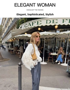 Street style view of yellow hollow-out leather underarm bag with white fringe sweater