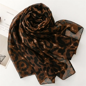 Detail of a lightweight leopard print scarf on a magazine showing sheer texture