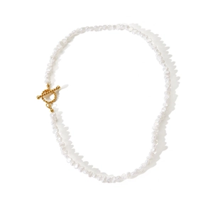 Detailed view of Baroque pearls with golden OT buckle and spiral metal textures