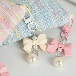 Pastel bow keychain with pearls and spring hook for bags in pink and beige colors