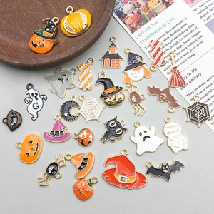 Flat lay of colorful Halloween charms including pumpkins, ghosts and witch hats for DIY jewelry