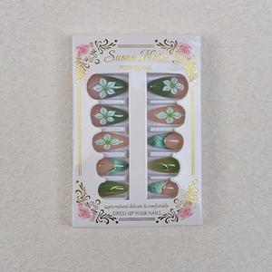Emerald green gradient press-on nails with 3D white flowers and gold foil star accents