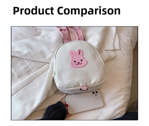 Mini canvas backpack with pink rabbit patch shown next to a smartphone for size reference