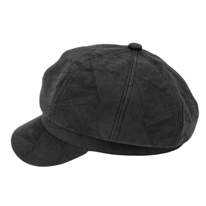 Detail of black faux suede newsboy cap featuring decorative geometric stitching and top button