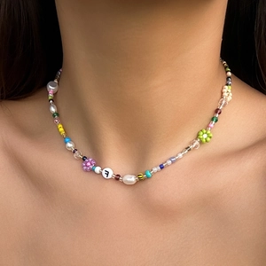 Colorful beaded necklace with daisy flowers, baroque pearls, and letter F charm