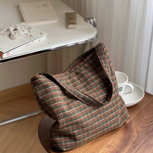 Close-up of retro plaid wool fabric and texture on a stylish vintage tote bag