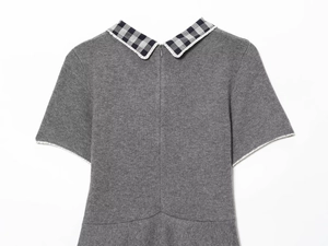 Detail of grey knit dress featuring a plaid collar and invisible back zipper closure