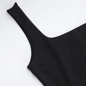 Detail of the neck and straps of a black vest showing high-quality stitching and fabric