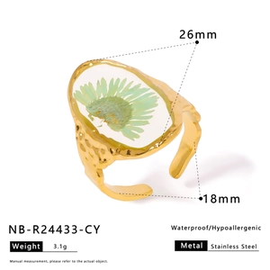Macro detail of handmade stainless steel ring with dried flower in resin inlay