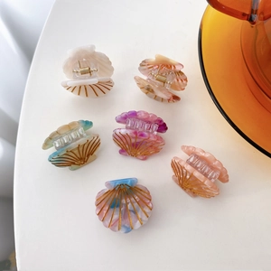 Set of six colorful shell-shaped acetate hair clips with elegant gold vein details