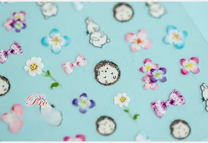 Macro detail of 5D nail art stickers featuring hand-drawn flowers, rabbits and hedgehogs