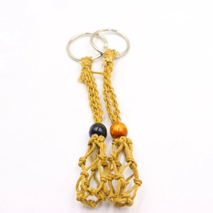 Detail view of handmade woven macrame mesh net keychains with decorative beads