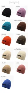 Detail of ribbed knit beanies with FBXS embroidery in multiple colors including orange