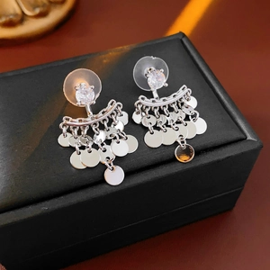 Detailed view of silver disc fringe tassel earrings displayed in a black jewelry box
