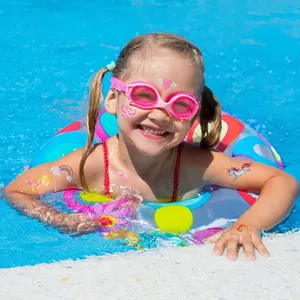 Girl with glitter waterproof tattoos featuring mermaid and unicorn designs by the pool