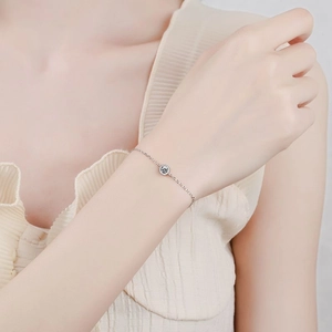 Elegant s925 sterling silver bubble bracelet with a single round moissanite on a female wrist