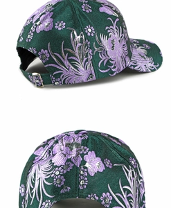 Macro detail of dark green satin baseball cap with phoenix and floral embroidery