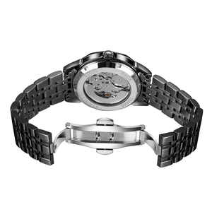 Detail of mechanical watch back with transparent skeleton case and stainless steel strap