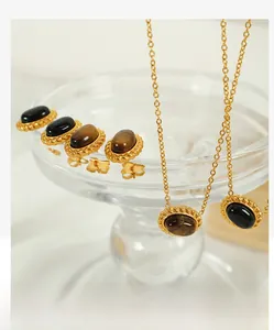 Macro shot of vintage gold necklaces and earrings with tiger eye and onyx inlays