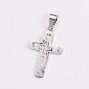 Close-up of a silver stainless steel double-layered cross pendant with small diamonds