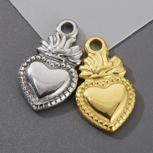 Detailed view of gold and silver stainless steel heart pendants with beaded edges