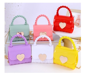 Selection of colorful mini jelly handbags featuring golden heart clasps and chain straps