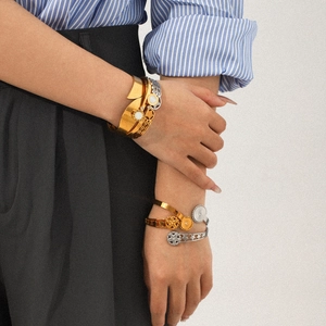 Polished 18k gold and silver stainless steel bangles set worn by model for style