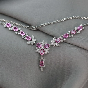 Luxury butterfly and floral necklace with pink gemstones and pavé diamonds on silk