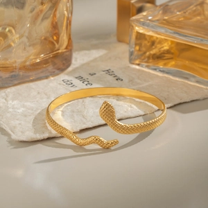 Minimalist gold snake-shaped open bracelet in durable stainless steel with scale texture