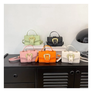 Detail of PU leather crossbody bags with ornate baroque gold buckles and fine textures